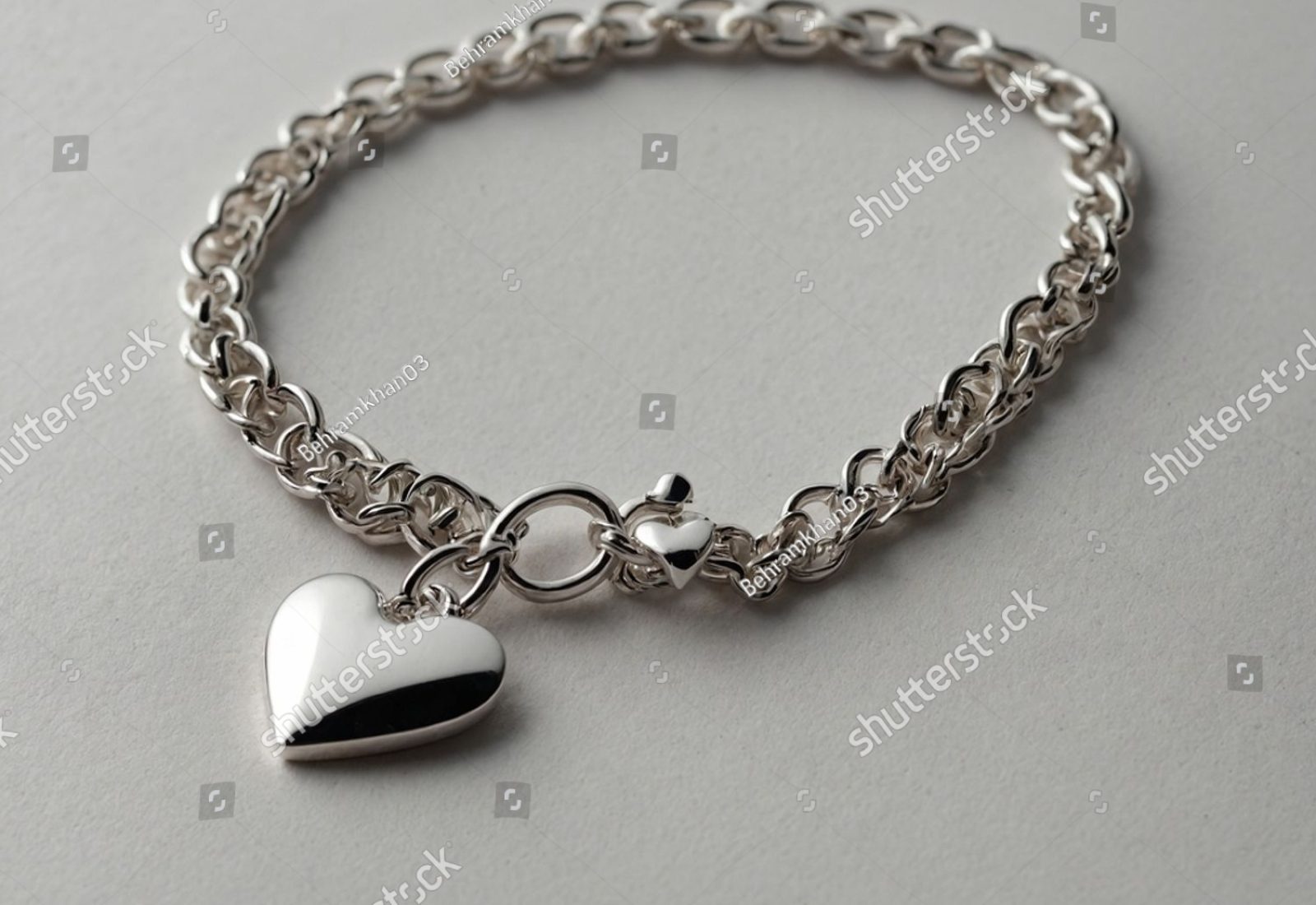 stock-photo-a-sleek-silver-heart-pendant-with-a-smooth-polished-finish-symbolizing-elegance-and-love-2634954583