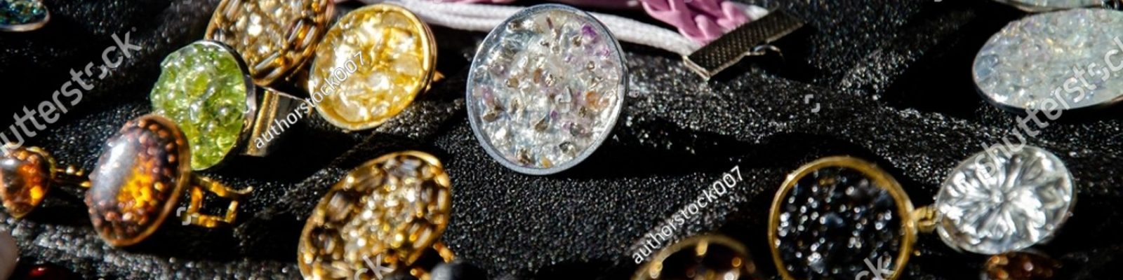 stock-photo-showcase-jewelry-made-of-mineral-and-precious-stones-rings-2548357287